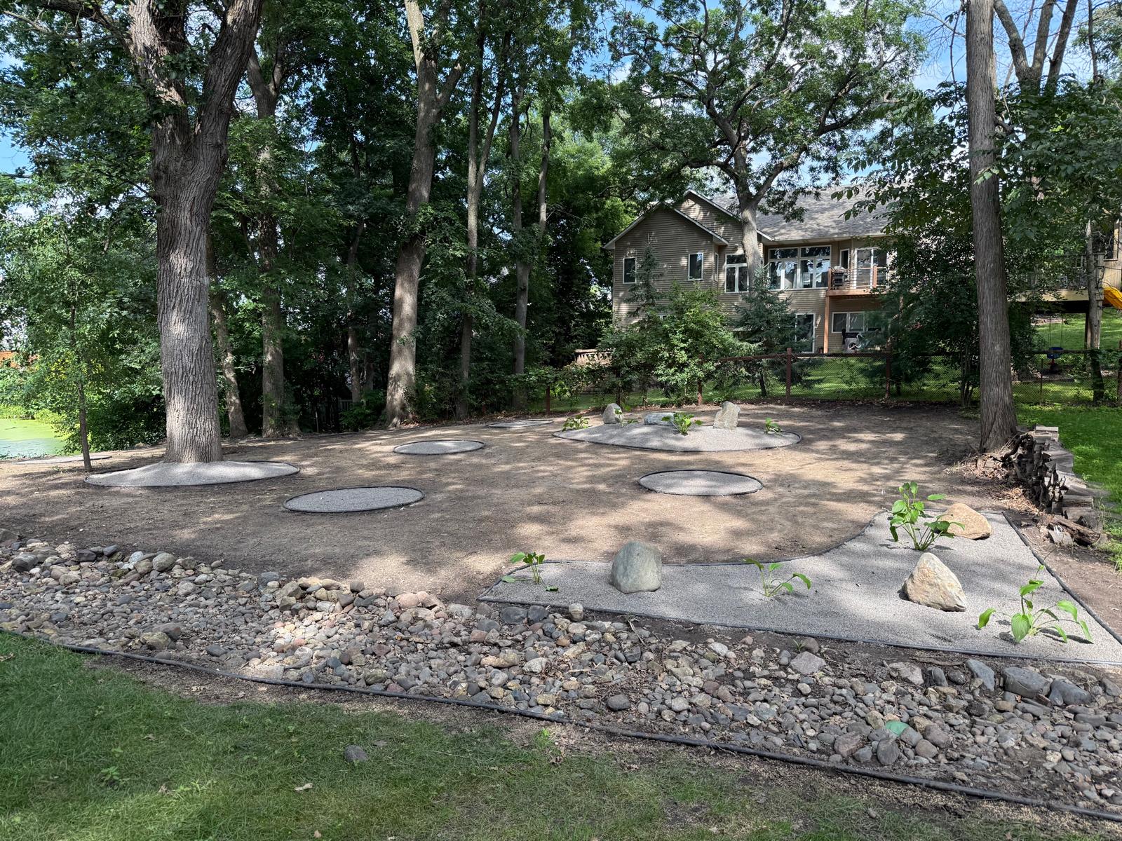 Boulder mulch bed with fresh plantings