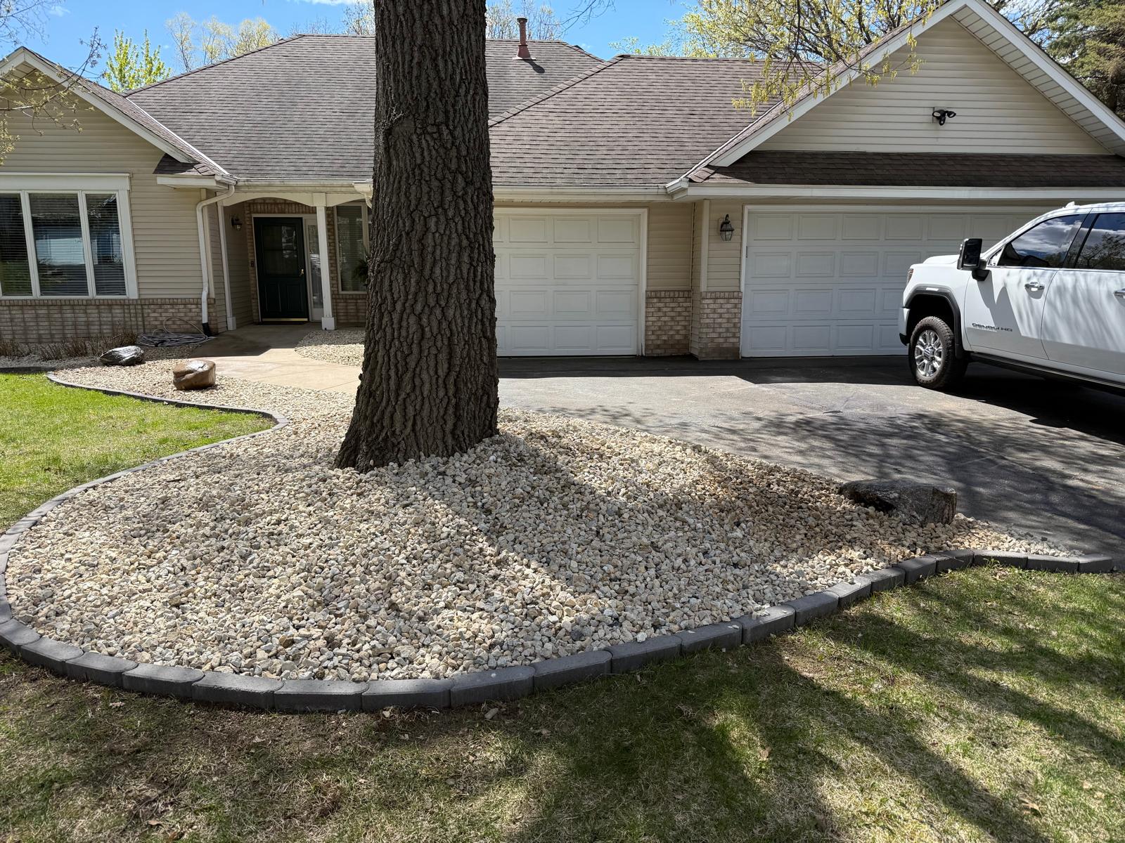 Front-yard rock bed with paver border